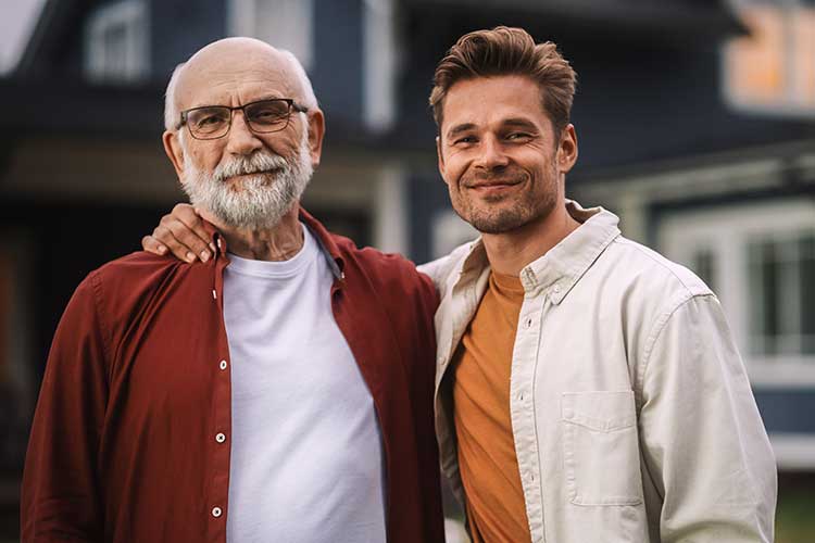 Father and adult son together smiling.
