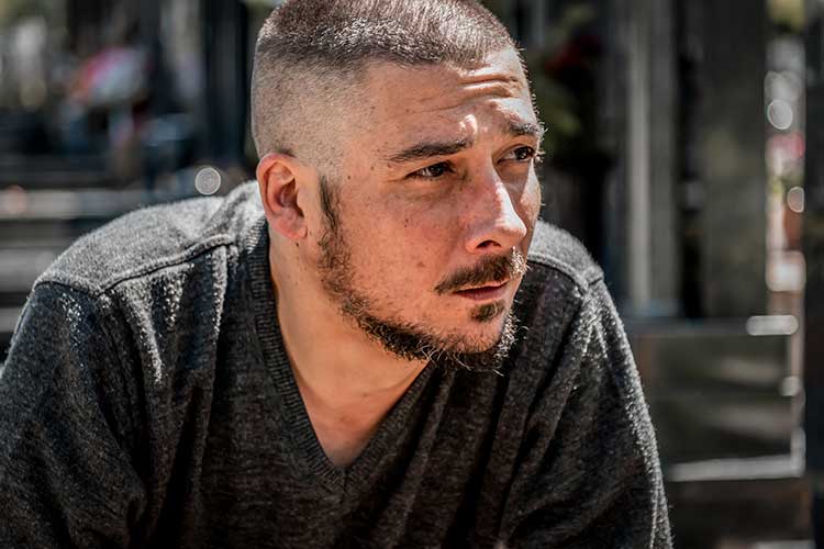 Man in the streets with a hopeless look due to drug addictions.