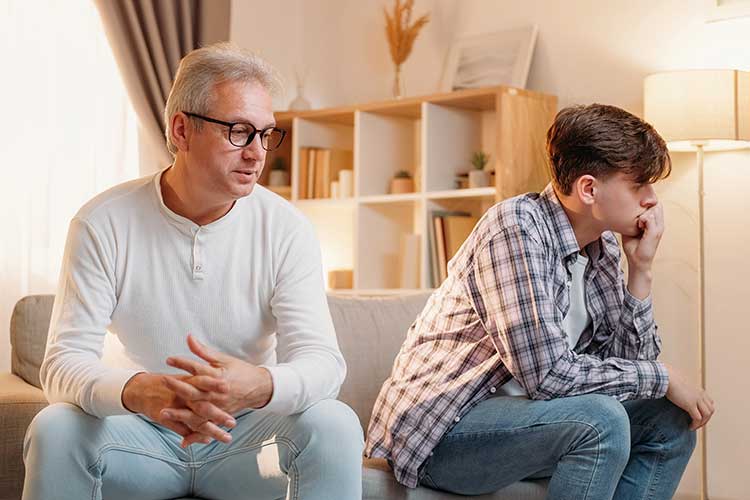 Father talking to teen about his addiction problem.