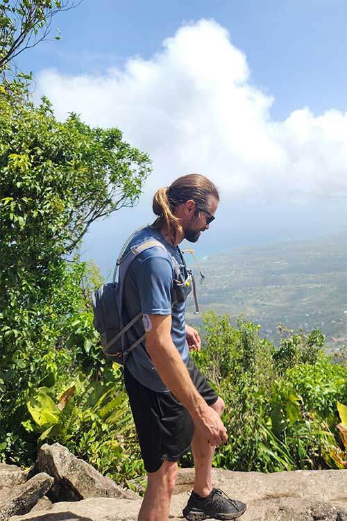 Man on cliff edge having overcome Hydrocodone Addiction Treatment for Men in Vista, CA​.