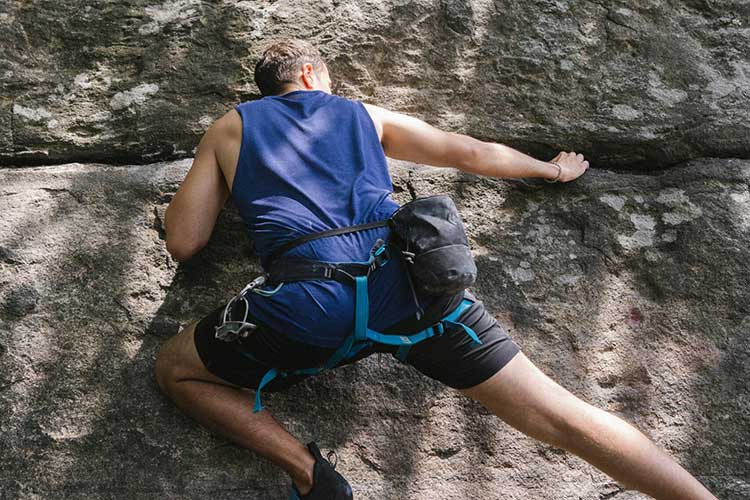 Man rock climbing on while participating in Fentanyl addiction treatment in Vista, CA.