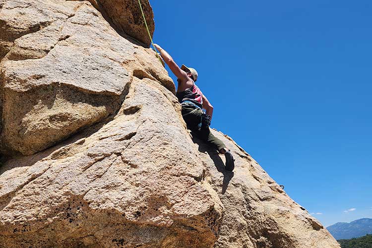 Man Rock climbing while in adventure therapy overcoming a prescription drug addiction in Vista, CA