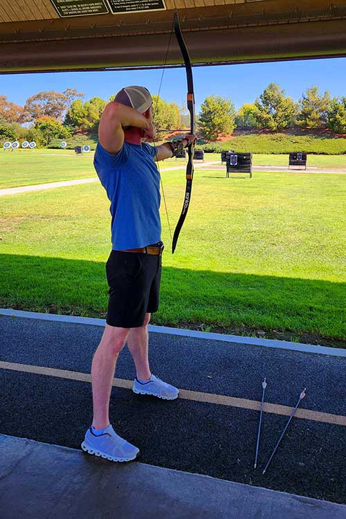 Man at archery range as part of Sacred Journey's Experiential therapy.