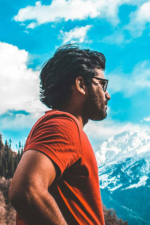 Man in red t-shirt in deep contemplation after experiencing mindfulness therapy for addiction recovery in Vista, CA.