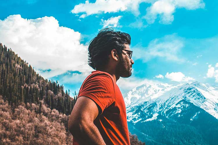 Man in red t-shirt in deep contemplation after experiencing mindfulness therapy for addiction recovery in Vista, CA.