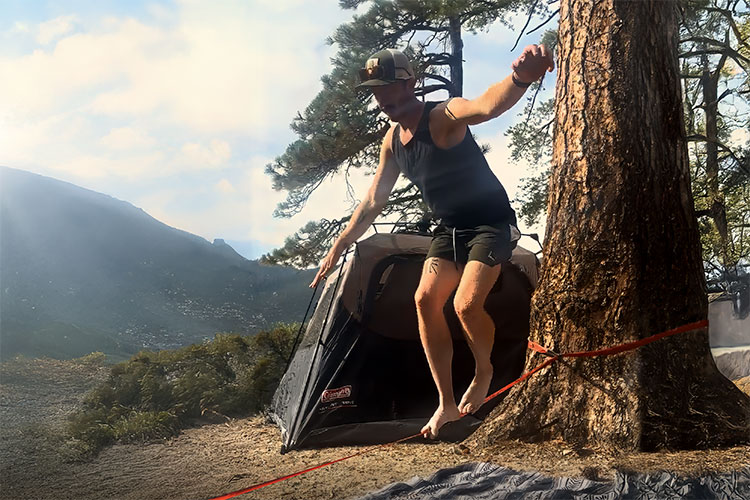 Image of man on slack line in the mountains as part of the Wilderness Therapy experience while camping in Southern California.