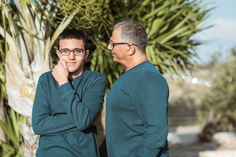 A photo of a father looking fondly at his son Convincing him to Go to Rehab at Sacred Journey in Vista, CA.