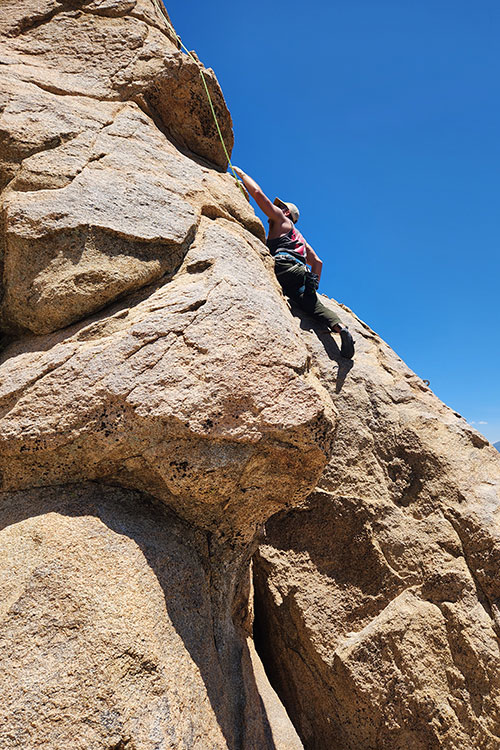 Man on cliff side as part of rock climbing for partial hospitalization addiction treatment (PHP) in Vista, CA.
