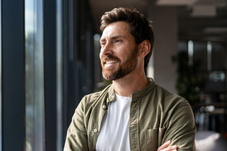 Man looking happy after reviewing his treatment plan and a smooth handoff between levels of coordinated care