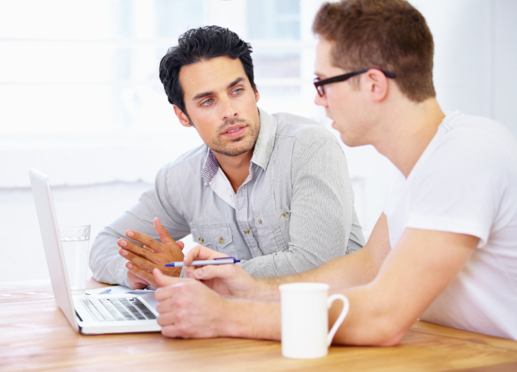 man talking to clinician about roadmap of addiction treatment stages from detox through residential to outpatient care