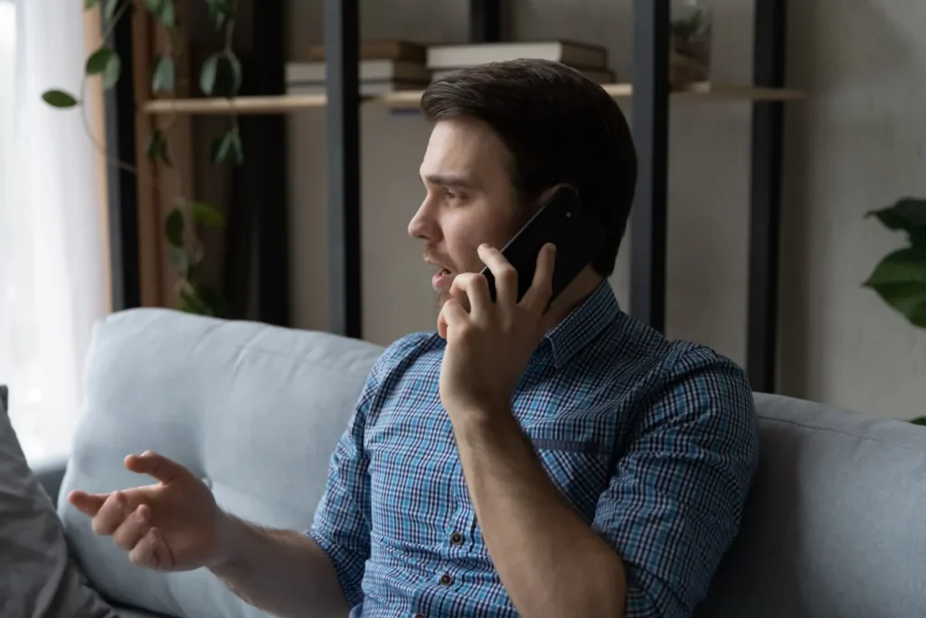 Compassionate admissions counselor talking with a man by phone during the first 48 hours of the rehab intake process